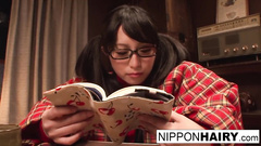 Passionate Japanese teen girl is reading erotic book and feeling horny before fingering pussy